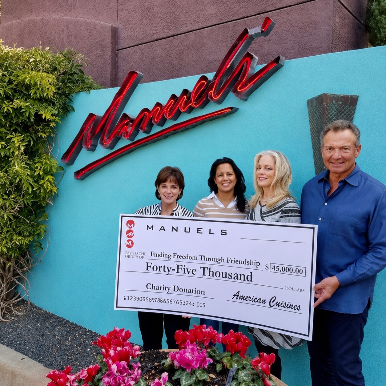 Greg Koury and three guests holding an oversized Manuel's cheque for forty-five thousand dollars made out to Finding Freedom Through Friendship, beneath the neon sign outside the restaurant