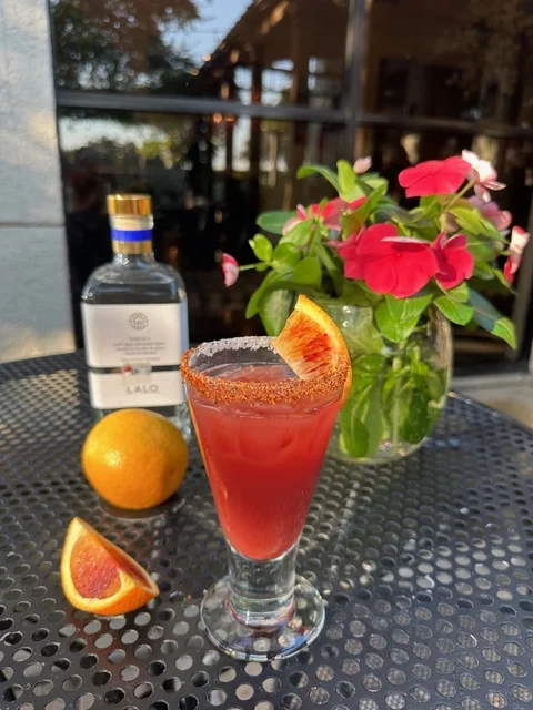 A blood orange margarita with a chile-salt rim and LALO tequila on Manuel's patio