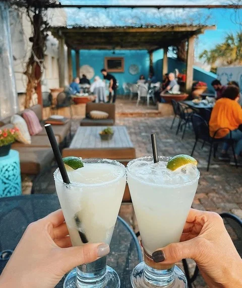 Two margaritas toasted over Manuel's tree-shaded patio